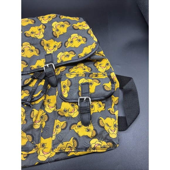 disney lion king faux leather backpack by loungefly X COLLECTORS OUTLET EXCLUSIVE SIMBA COSPLAY MINI IN STOCK! it is made of faux leather and features a top zipper closure and front zippered pocket Loungefly Lion King Faces Embroidered